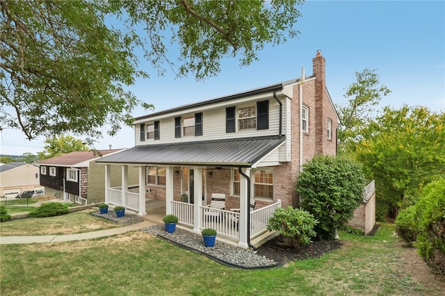 back of house with a porch and a yard