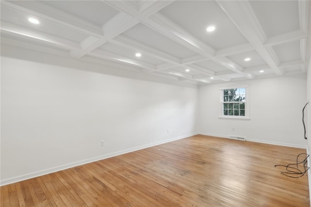 unfurnished room featuring beamed ceiling, coffered ceiling, and light hardwood / wood-style floors