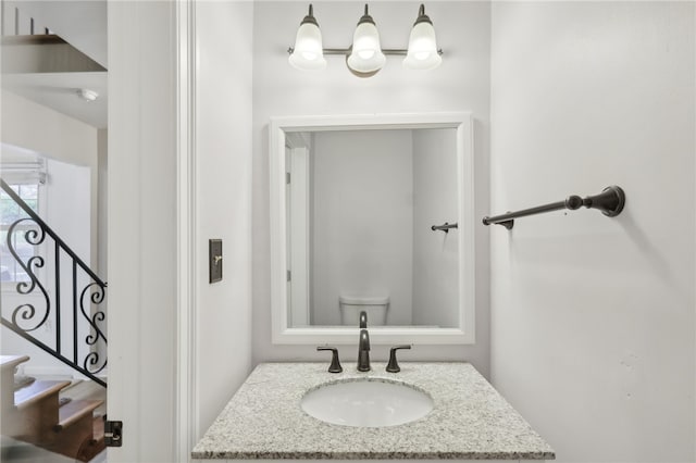 bathroom featuring toilet and vanity