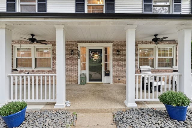 entrance to property featuring a porch and ceiling fan