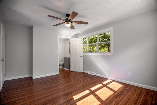 unfurnished room with a textured ceiling, ceiling fan, and dark hardwood / wood-style flooring