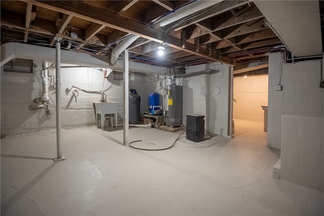 basement featuring gas water heater and sink