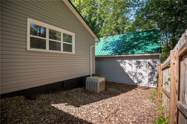 view of side of home with central air condition unit