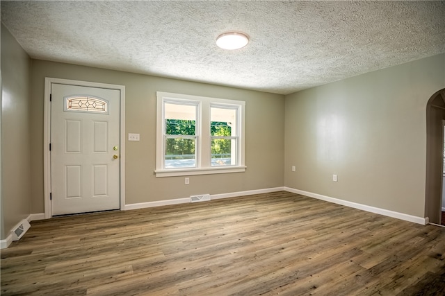 foyer with a textured ceiling and hardwood / wood-style floors