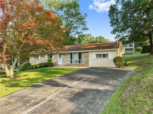 ranch-style home with a front lawn