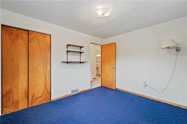 unfurnished bedroom featuring carpet floors and a closet