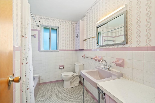 full bathroom with sink, tile patterned flooring, toilet, shower / tub combo with curtain, and tile walls