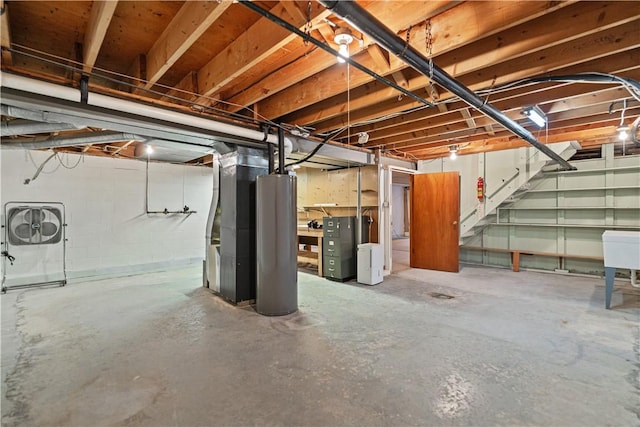 basement featuring heating unit and water heater