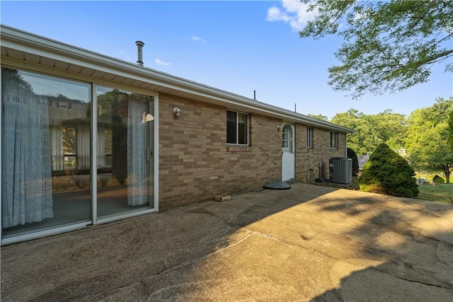 back of house with a patio and central AC unit