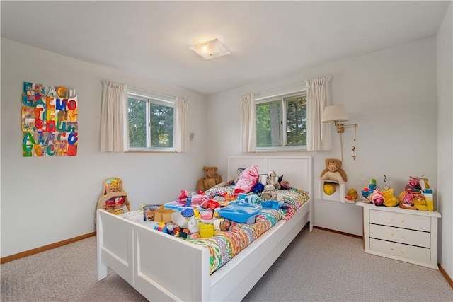 bedroom featuring light colored carpet and multiple windows