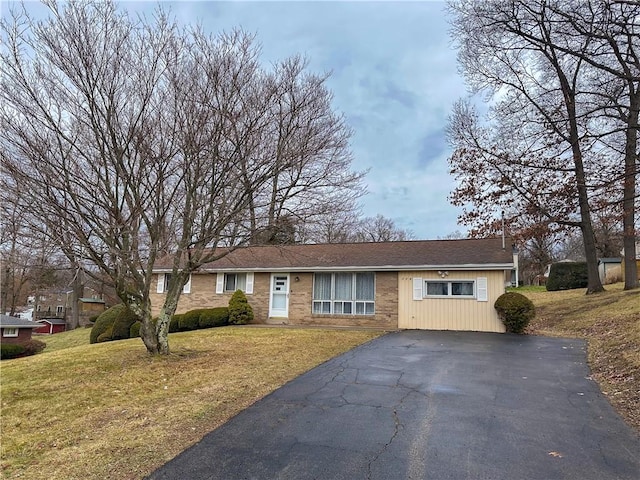 ranch-style home with a front lawn