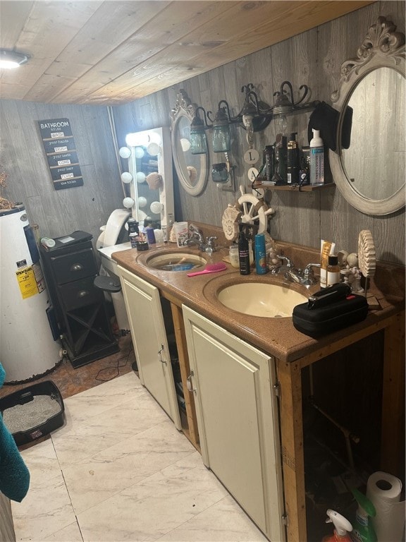 bathroom with gas water heater, vanity, wooden walls, and wood ceiling