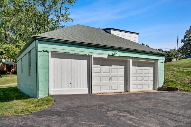 garage featuring a yard