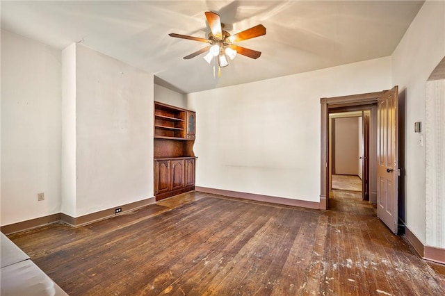 spare room featuring dark hardwood / wood-style floors and ceiling fan