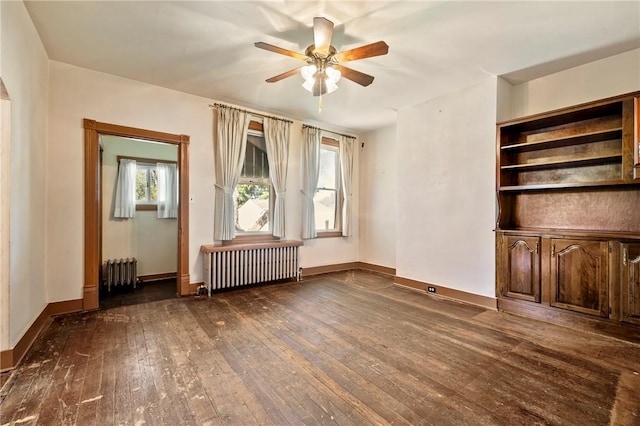 unfurnished living room with ceiling fan, dark wood-type flooring, and radiator