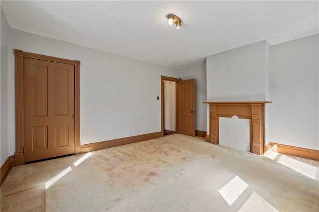 unfurnished living room with light colored carpet