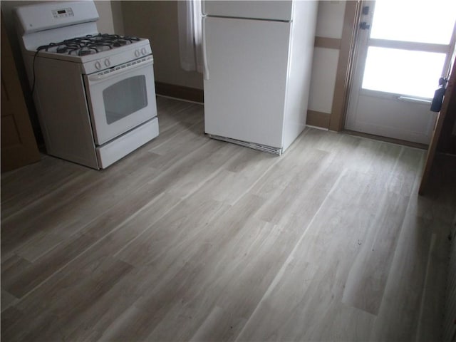 kitchen featuring light hardwood / wood-style floors and white appliances