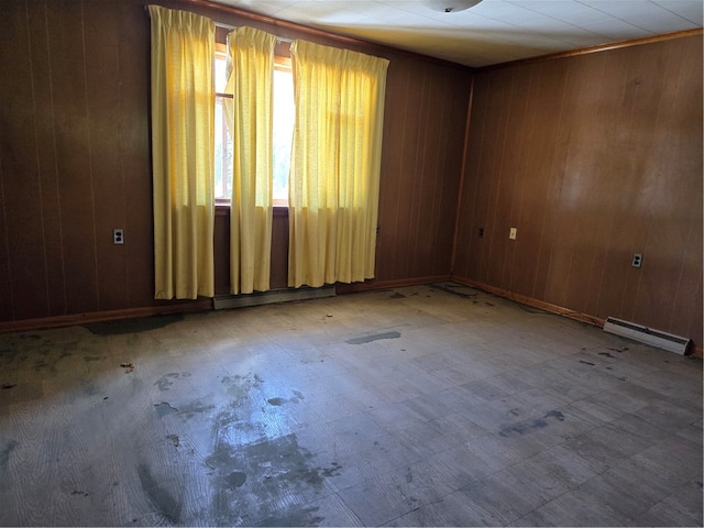 unfurnished room with a baseboard radiator and wooden walls