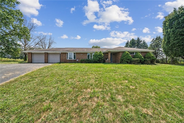 ranch-style home with a garage and a front yard