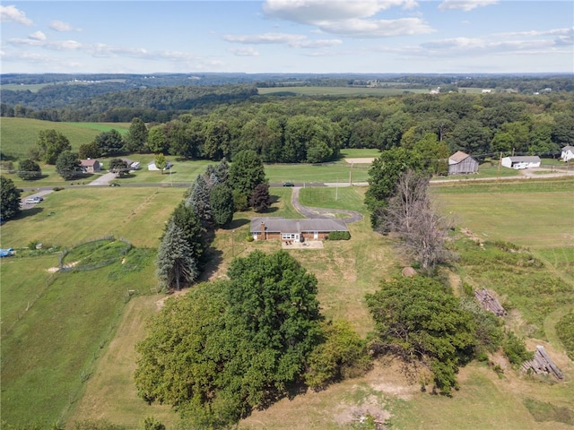 birds eye view of property featuring a rural view and a wooded view