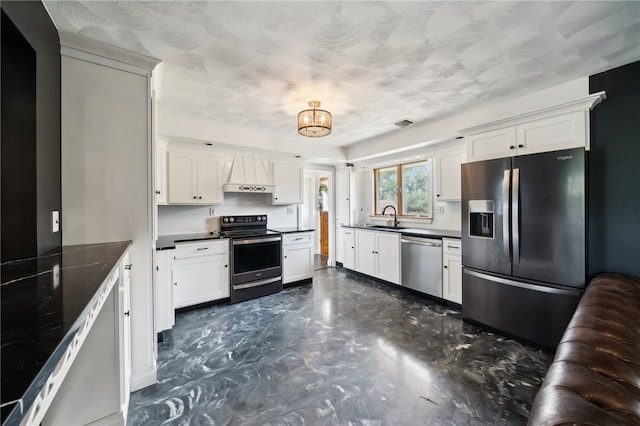 kitchen featuring custom range hood, sink, appliances with stainless steel finishes, and white cabinets