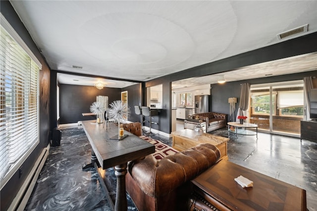 living room featuring a baseboard radiator and concrete floors