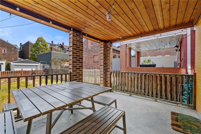 view of patio / terrace with a storage shed and a garage