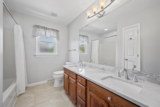 full bathroom featuring shower / bath combination with curtain, toilet, and vanity