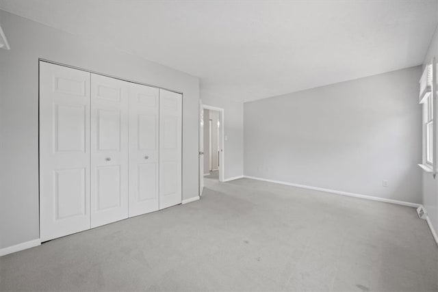 unfurnished bedroom with carpet floors and a closet