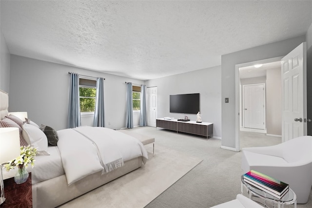 carpeted bedroom featuring a textured ceiling