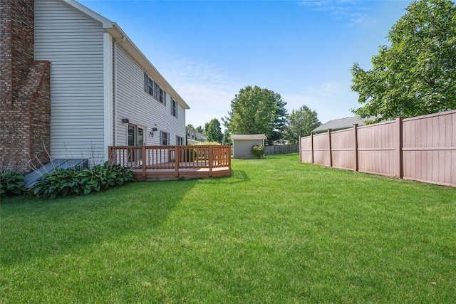 view of yard with a shed and a wooden deck