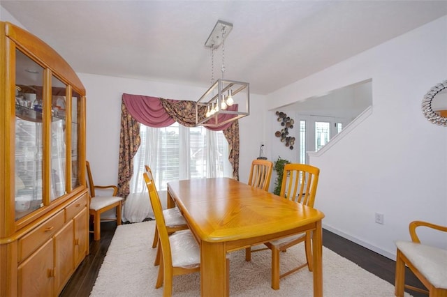 dining space featuring plenty of natural light and dark hardwood / wood-style floors