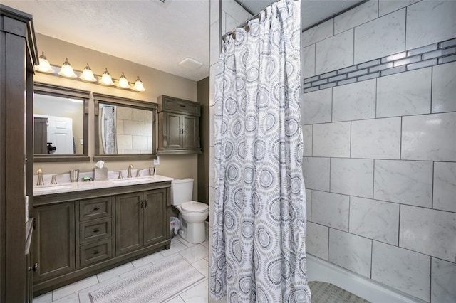 bathroom featuring vanity, tile patterned floors, a shower with shower curtain, toilet, and a textured ceiling