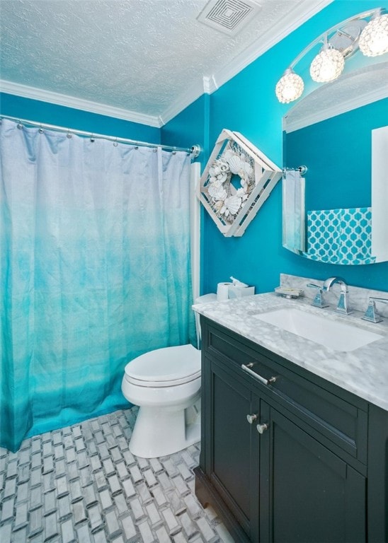 bathroom featuring a textured ceiling, toilet, and crown molding