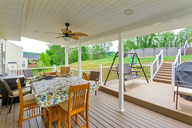 deck featuring a lawn and ceiling fan