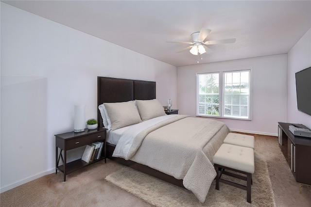 bedroom featuring ceiling fan and light carpet