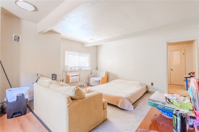 living room with light colored carpet, beam ceiling, and a wall mounted air conditioner