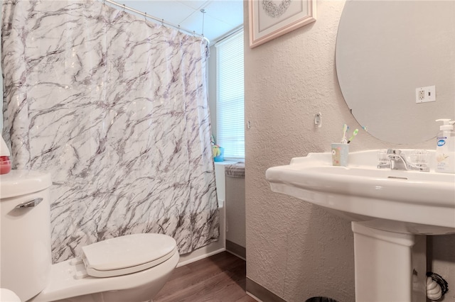 bathroom featuring a shower with curtain, toilet, and hardwood / wood-style flooring