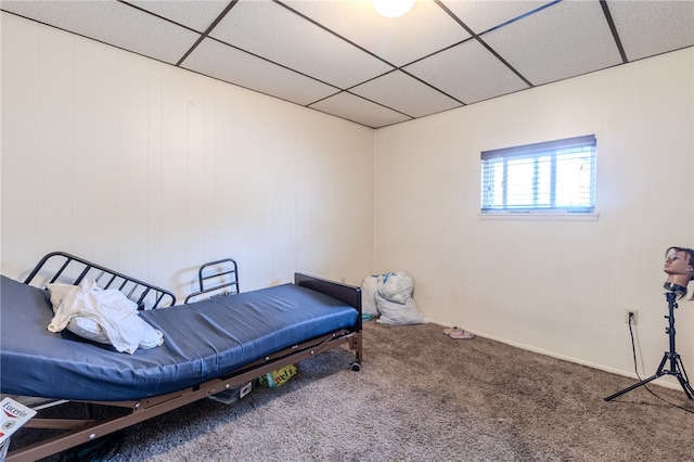 carpeted bedroom featuring a paneled ceiling