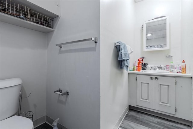 4900 Walnut St, Versailles Boro, PA 15132 - bathroom featuring baseboards, wood finished floors, toilet, and vanity