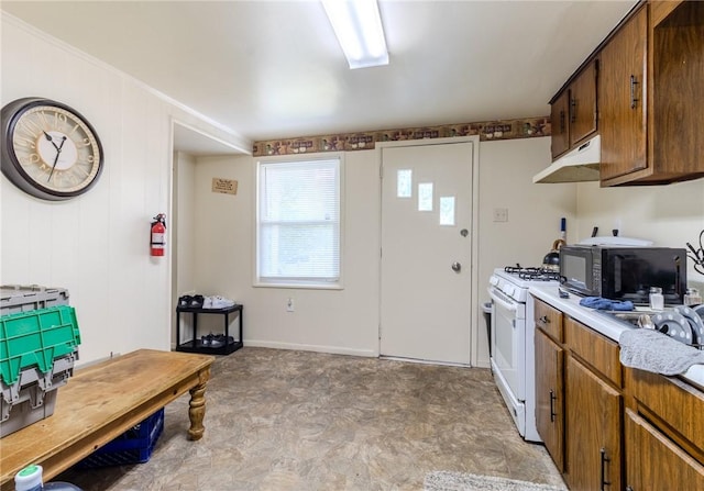 4900 Walnut St, Versailles Boro, PA 15132 - kitchen with black microwave, light floors, white gas range, light countertops, and under cabinet range hood