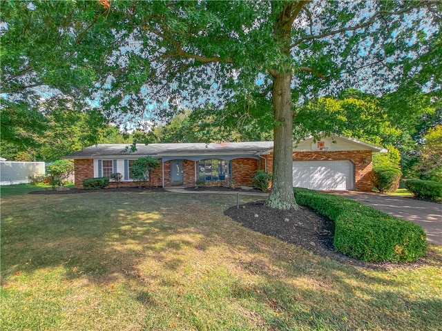 ranch-style home featuring a garage and a front lawn