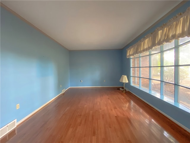 unfurnished room featuring wood-type flooring