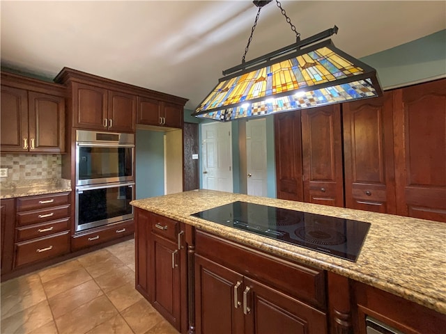 kitchen with stainless steel double oven, backsplash, light tile patterned floors, light stone countertops, and black electric cooktop