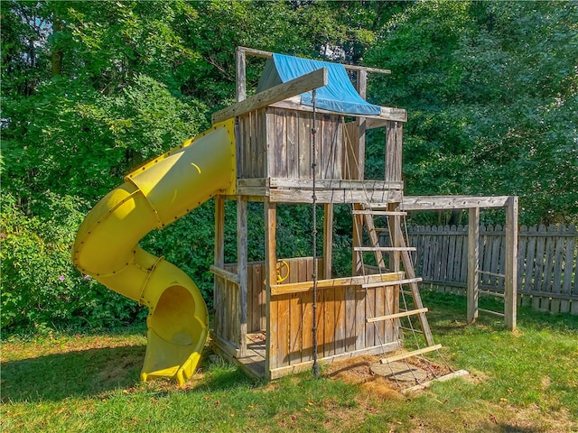 view of playground with a lawn