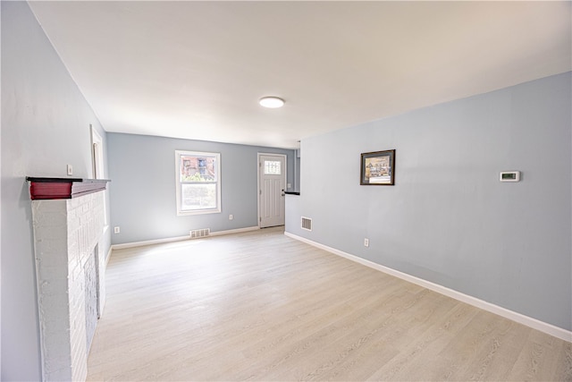 interior space featuring a fireplace and light hardwood / wood-style flooring