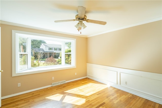 unfurnished room featuring ceiling fan, ornamental molding, and light hardwood / wood-style floors