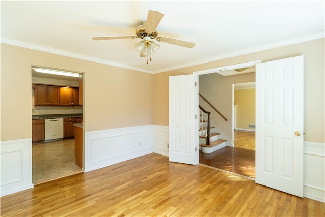 empty room with crown molding, ceiling fan, and light hardwood / wood-style floors