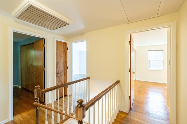 hallway with hardwood / wood-style floors