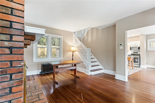 interior space featuring radiator heating unit and hardwood / wood-style flooring